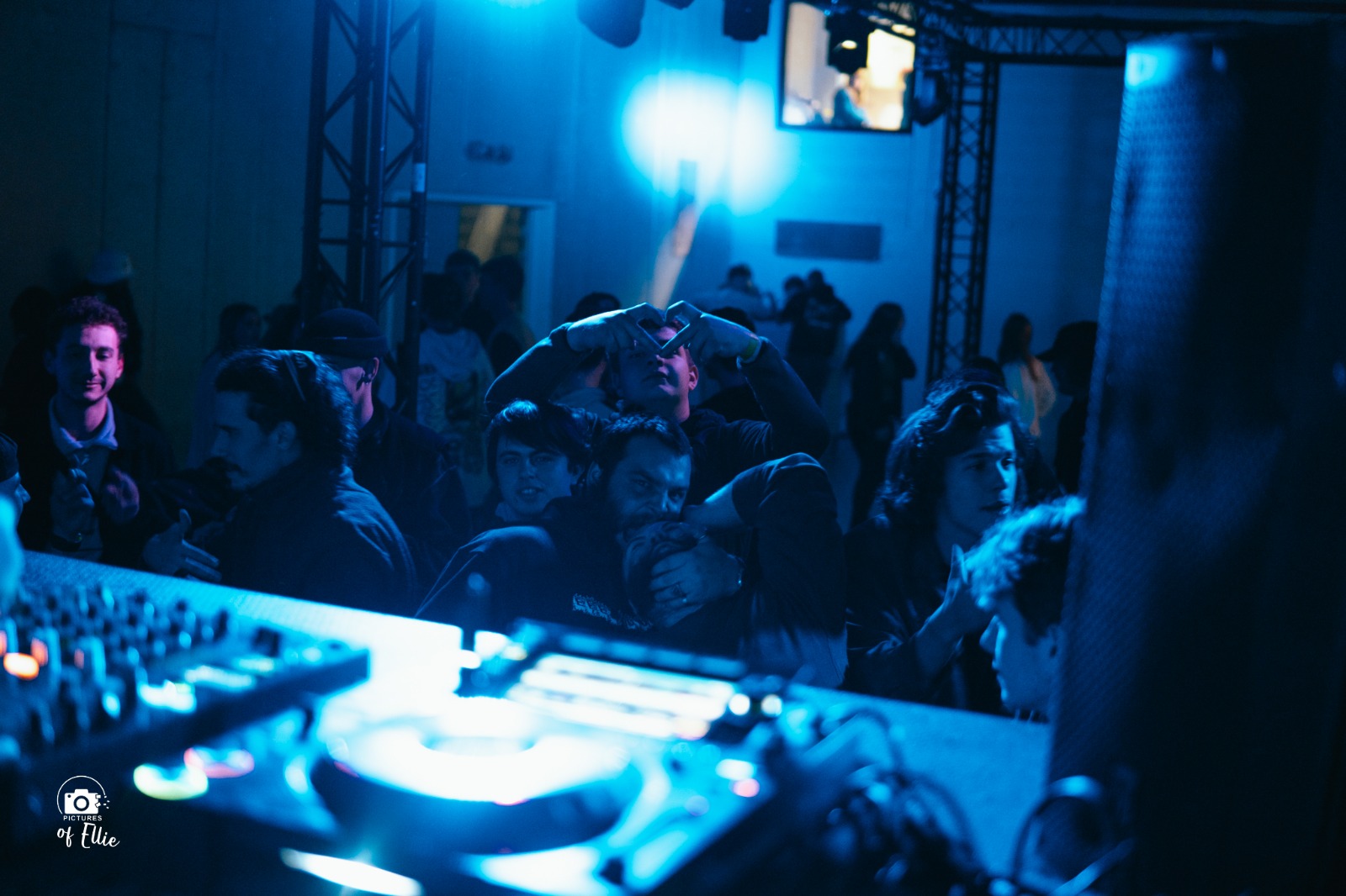 Feestend publiek bij een dj-set met blauw licht