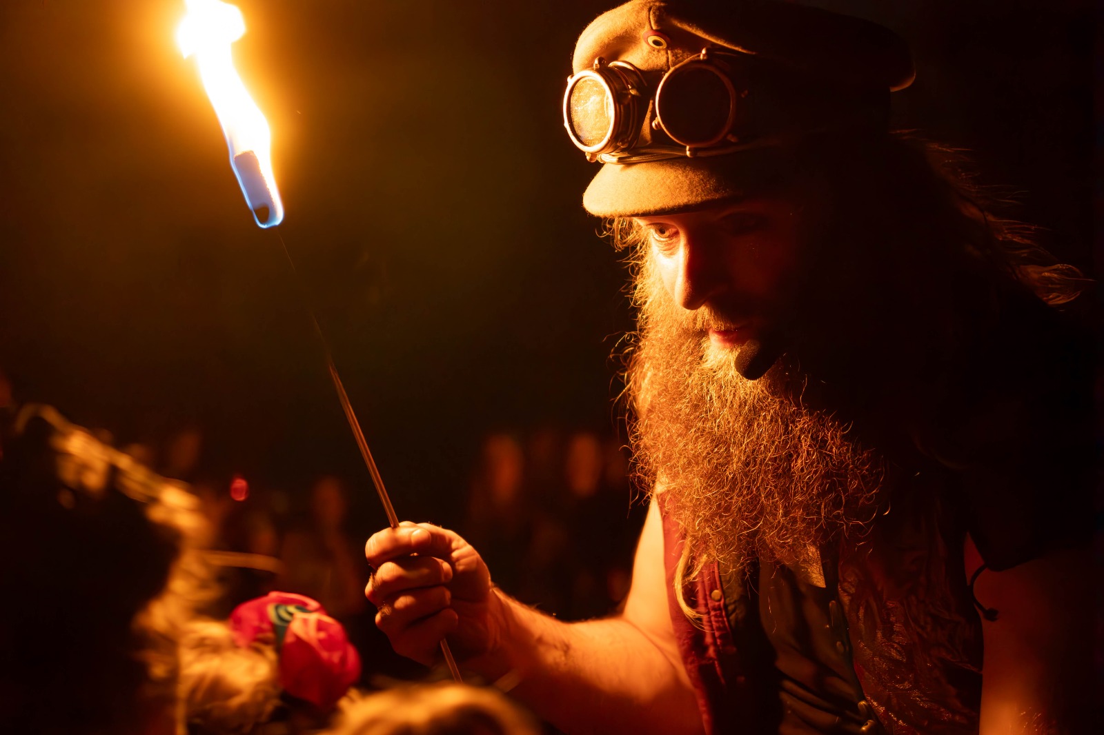 Vuurperformer met steampunk-bril en vlam